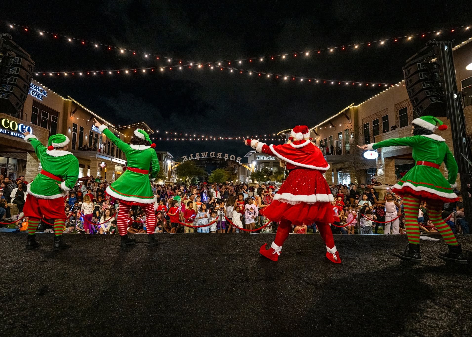 Live entertainment on stage during the Light the Towne holiday celebration at The Boardwalk Towne Lake.