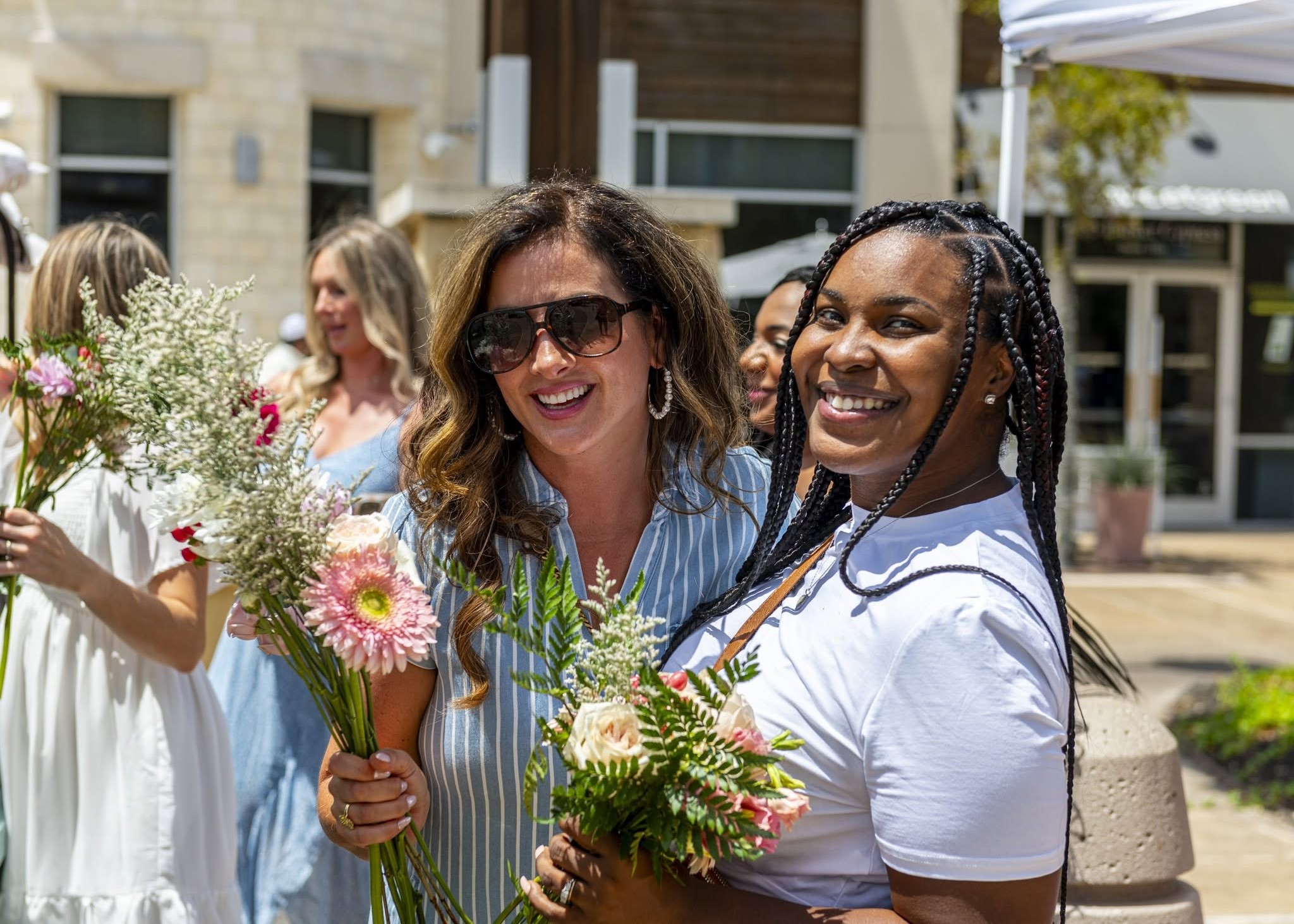 Guests selecting fresh flowers from the Flower Truck at The Boardwalk Towne Lake community event.