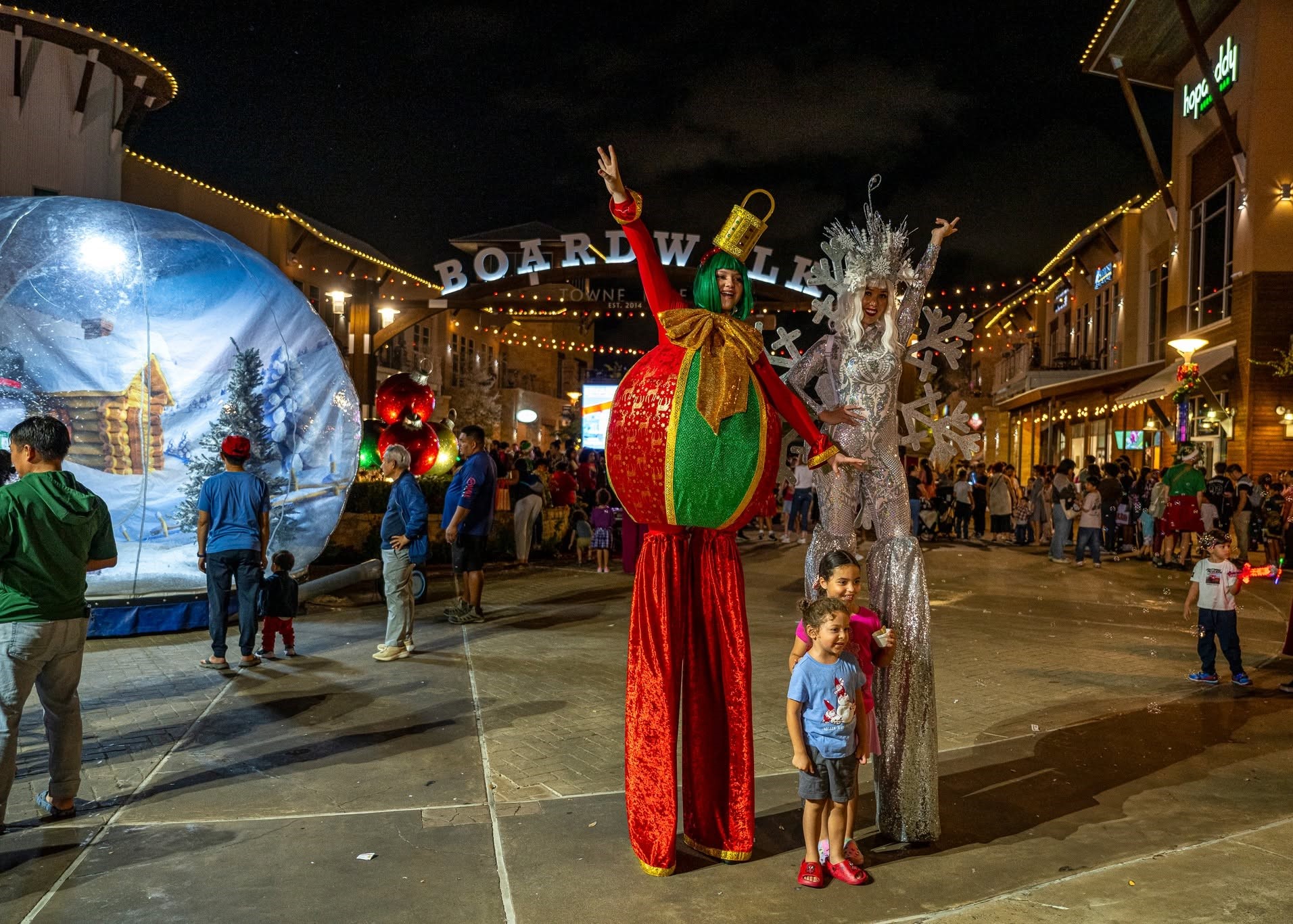 Families celebrating the annual Light the Towne holiday event at The Boardwalk Towne Lake.